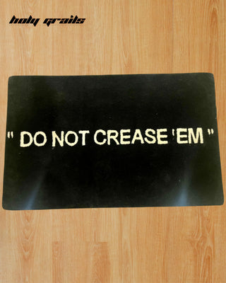 'Do Not Crease 'Em' Handtufted Rug on Floor