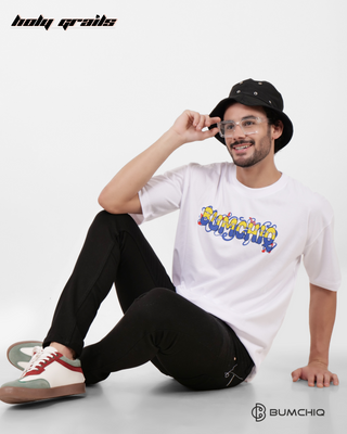 Guy in Streetwear Style 'Minions' White 240 GSM French Terry Cotton T-Shirt - Front Sitting on the floor