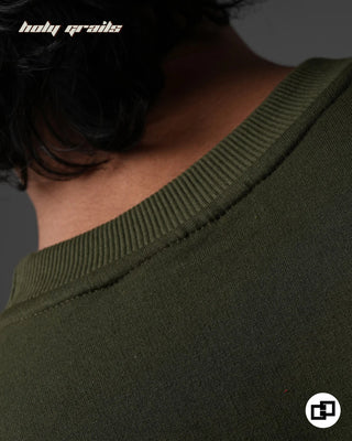 Guy in Streetwear Style 'Not So Basic' Military Green 240 GSM 100% Cotton Embroidered Oversize T-Shirt HG x Grey Hound - Back Collar Close Up