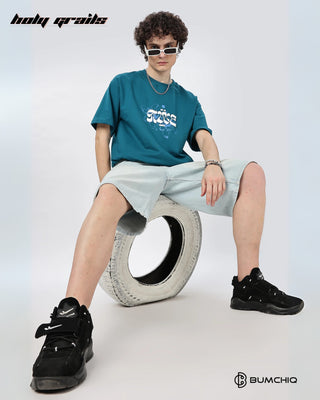 Guy in Street Style 'Wake Up' Teal 240 GSM 100% Terry Cotton Screen Printed Oversize Graphic Tee HG x Bumchiq - Front Sitting on Tyre