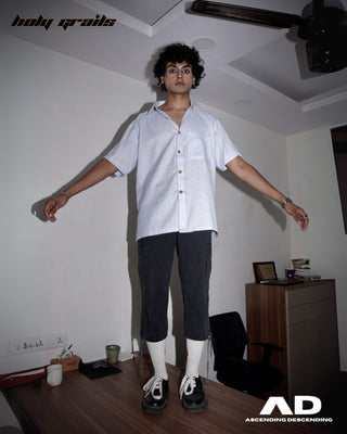 Men wearing a Street Style 'Switch' Blue & White Stripes Cotton Convertible Shirt and dark pants with short sleeves in an indoor setting standing on a Desk - Front