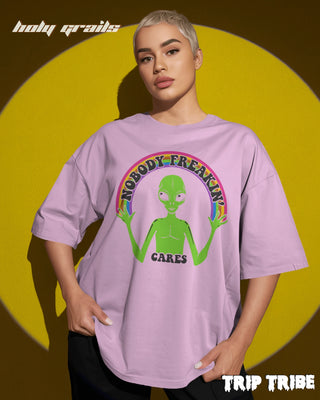 Women in Street Style '👽 Nobody Freakin’ Cares' Light Baby Pink 240 GSM 100% Cotton Oversize Tee HG x Trip Tribe - Front