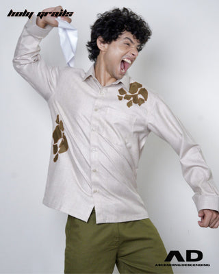Angry men throwing paper wearing a cream shirt with brown abstract patterns