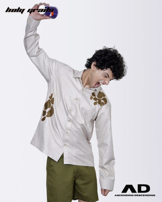 Angry person throwing a paper cup wearing a cream full sleeve shirt with abstract patterns and green shorts