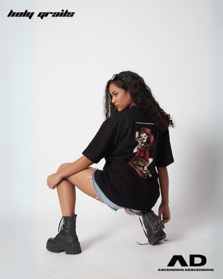 Girl in Streetwear Style 'Hukkum Ki Rani' Black Oversized 250GSM French Terry Knit Cotton T-Shirt  - Back while Sitting on the toe & Heel