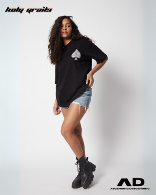 Girl in Streetwear Style 'Hukkum Ki Rani' Black Oversized 250GSM French Terry Knit Cotton T-Shirt  - Front Paired with Blue Denim Shorts & Black Boots