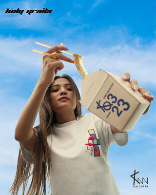 Girl in Streetwear Style 'The Sketcherbook Tee' White Oversized 260 GSM French Terry Cotton T-Shirt - Front Eating Ramen with Chopstick