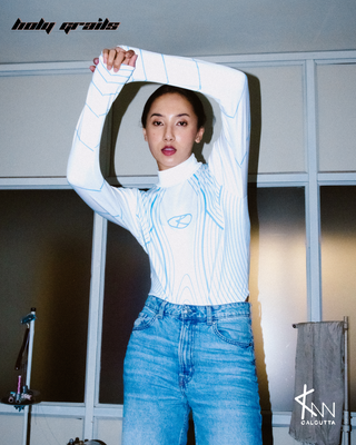 Girl in Streetwear Style 'YKK' White Poly Spandex Bodysuit - Front Hands Up