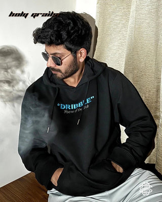 Guy Sitting in Streetwear Style 'Turn the Feeling Off' Black 325 GSM Cotton 60% Polyester 40% Oversize Hoodie HG x DRBL - Front