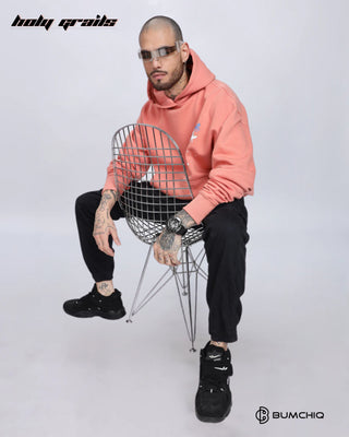 Guy Sitting on Chair in Streetwear Style 'Chill Coral' Pink 350-370 GSM Puff Print Oversize Graphic Hoodie HG x Bumchiq - Front Side