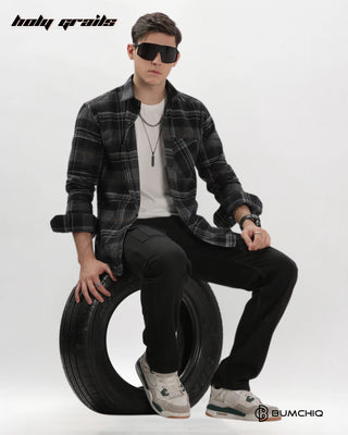 Guy Sitting on Tire in Streetwear 'Black Flannel' Full Sleeve 100% Cotton Checkered Overshirt HG x Bumchiq - Front