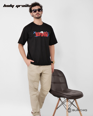 Guy in Streetwear Style 'Popeye' Black 240 GSM French Terry Cotton T-Shirt - Front Hand on Chair