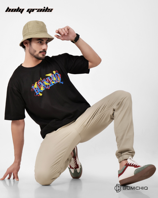 Guy in Streetwear Style 'Tom & Jerry' Black 240 GSM French Terry Cotton T-Shirt - Front Sitting Pose