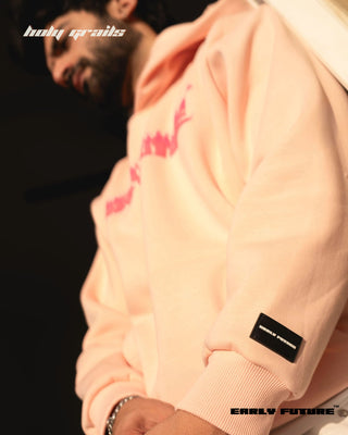 Guy Standing in Street Style 'Not a Pink Panther' Peach Haze Unisex 360 GSM 100% Cotton Fleece Puff and Screen Graphic Printed Oversize Fit Hoodie - Sleeve Close Up