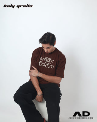 Guy in Streetwear Style 'Devnagri' Arri Maroon Red 250 GSM Knitted Tencel Tee HG x Ascending Descending - Front Sitting on the floor