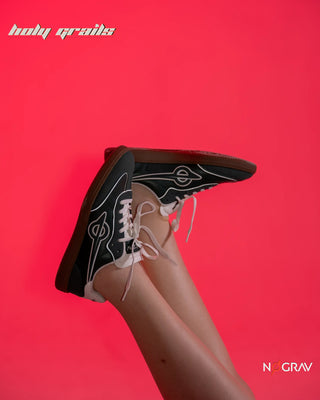 Women wearing Homegrown 'Dirty Martini' Deep Green Premium PU Upper, Cushioned Footbed, Eva Midsole & Rubber Outsole Lightweight Sneaker HG x NoGrav - Side in Feet, legs in the air over