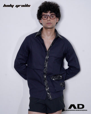 Man wearing a black shirt with decorative patterns on a white background