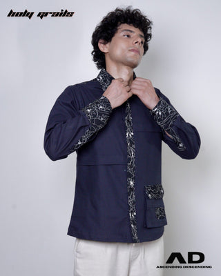 Man wearing a black embroidered shirt on a white background