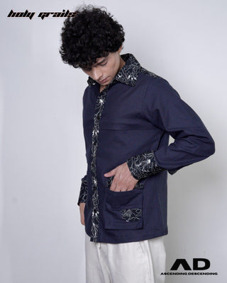 Person wearing a black full sleeve shirt with intricate patterns on a white background