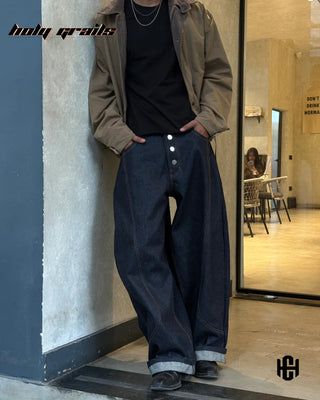 Men in 'Indigo Studio' Blue 12 Oz Premium Denim Unisex Fit Baggy Jeans HG x Charactr - Front Full Lean on Wall