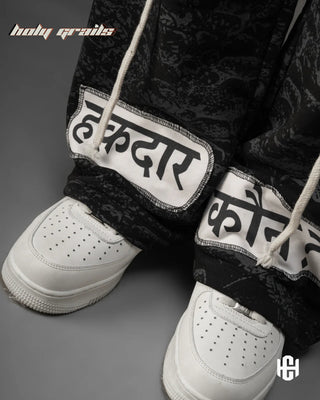 Men in 'Manushya Karam' Black Unisex 320 GSM 100% Cotton Fleece Digital Printed Baggy Pants HG x Charactr - Front Feet Close Up
