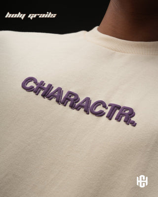 Men in 'The Fortune' Cream 240 GSM Terry Cotton Puff Print Graphic Oversize T-Shirt HG x Charactr - Front Close Up